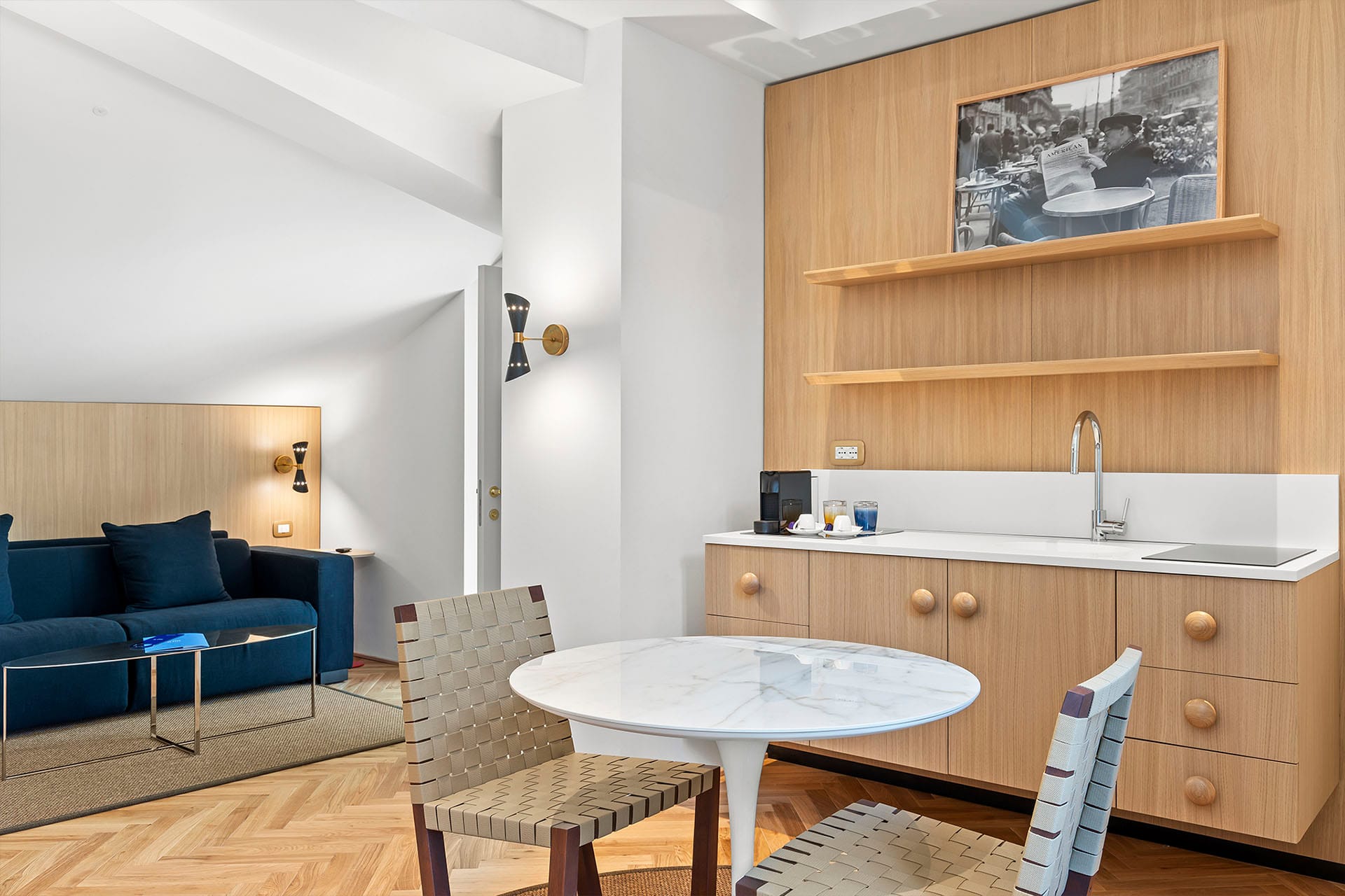 Detail of Prestige Quadruple Room with sitting area and kitchenette with dining table